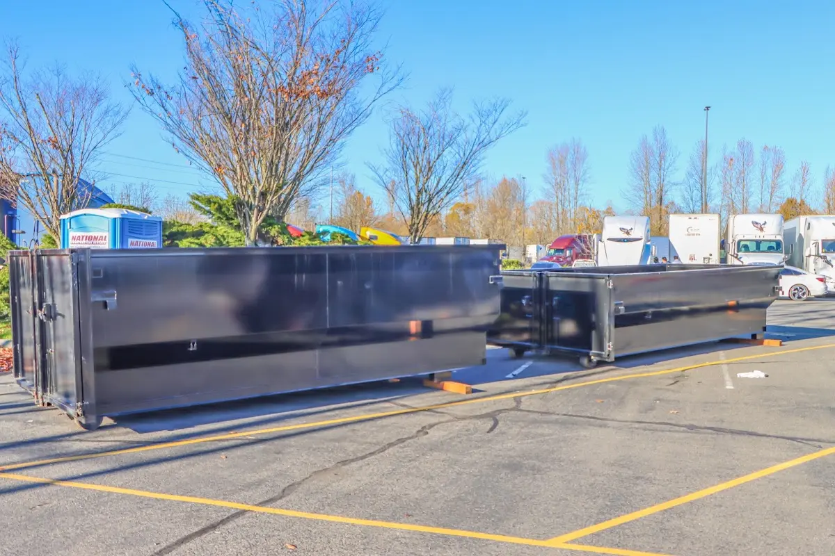 Professional dumpster rental service with roll-off container on residential driveway in Contra Costa Centre